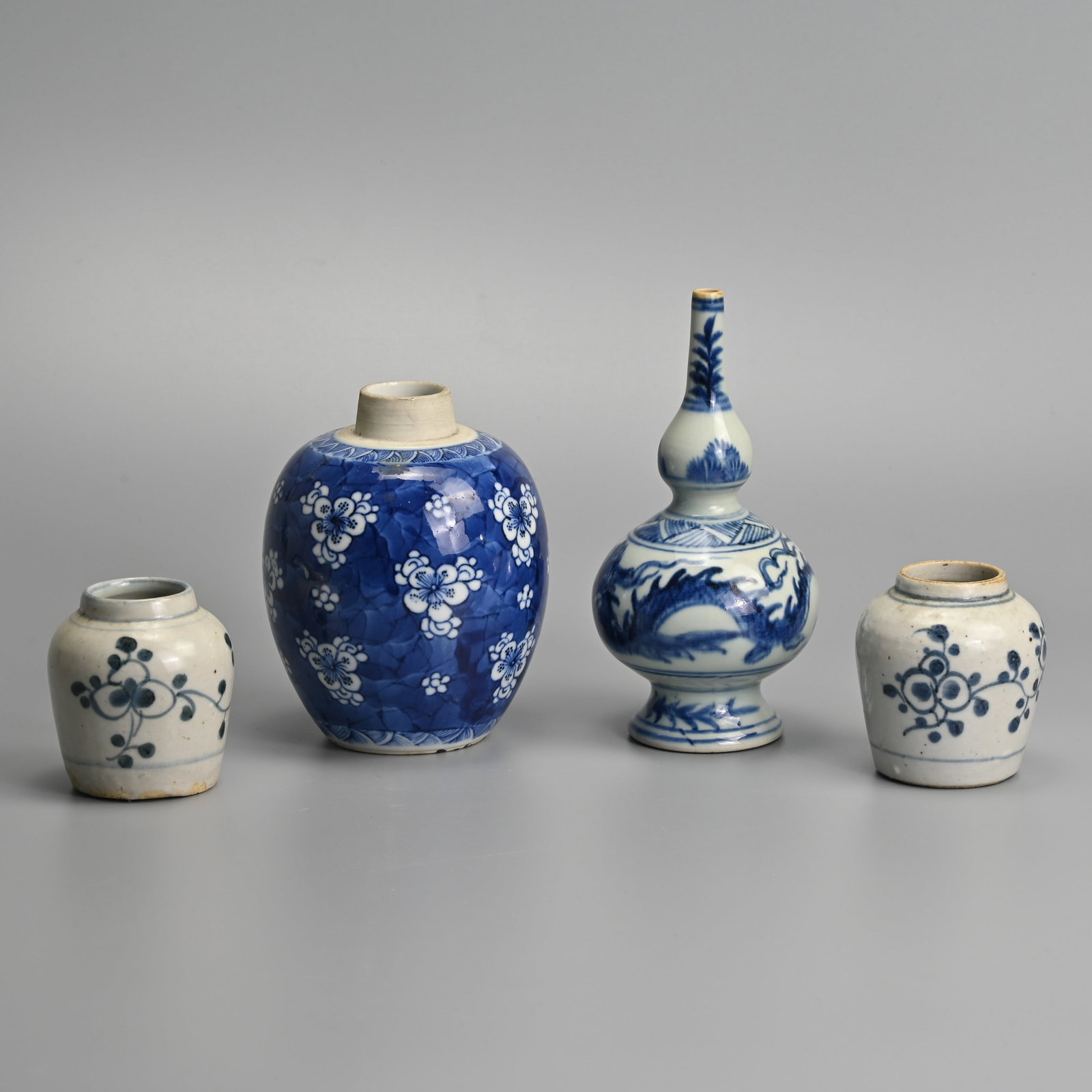A GROUP OF CHINESE BLUE AND WHITE PORCELAIN ITEMS, 18/19TH CENTURY.: To include a rose water sprinkler decorated with a dragon in flight amidst clouds; A ovoid prunus jar with four character mark of Chenghua to base; Together with a close pair of jars, late Ming dynast