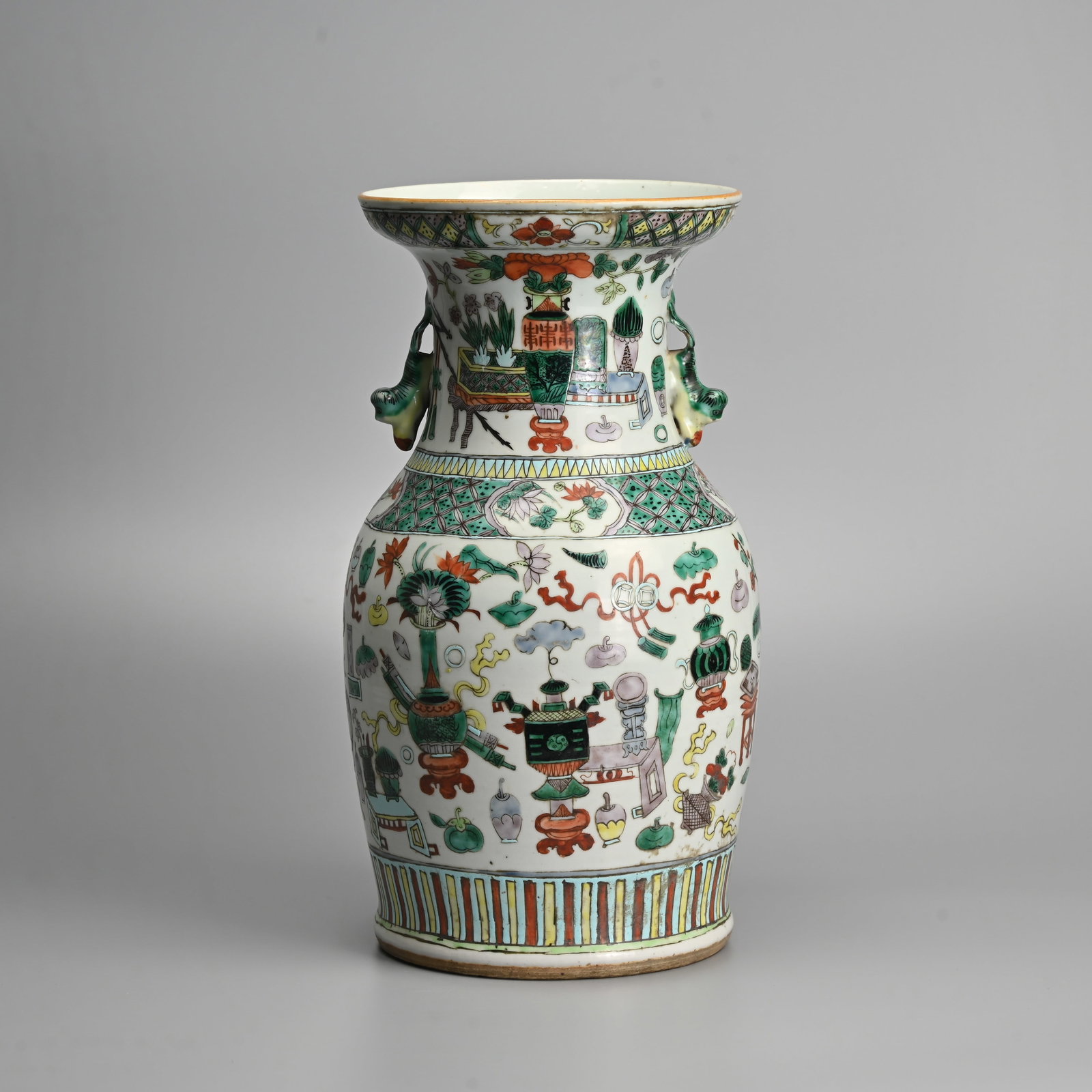 A CHINESE FAMILLE VERTE 'TREASURED OBJECTS' PORCELAIN VASE, 19TH CENTURY.: Of baluster form with downward facing lion handles, decorated with various treasured objects, also known as 'Bogu' or 'Hundred Treasures' decoration. 34.5cm tall.