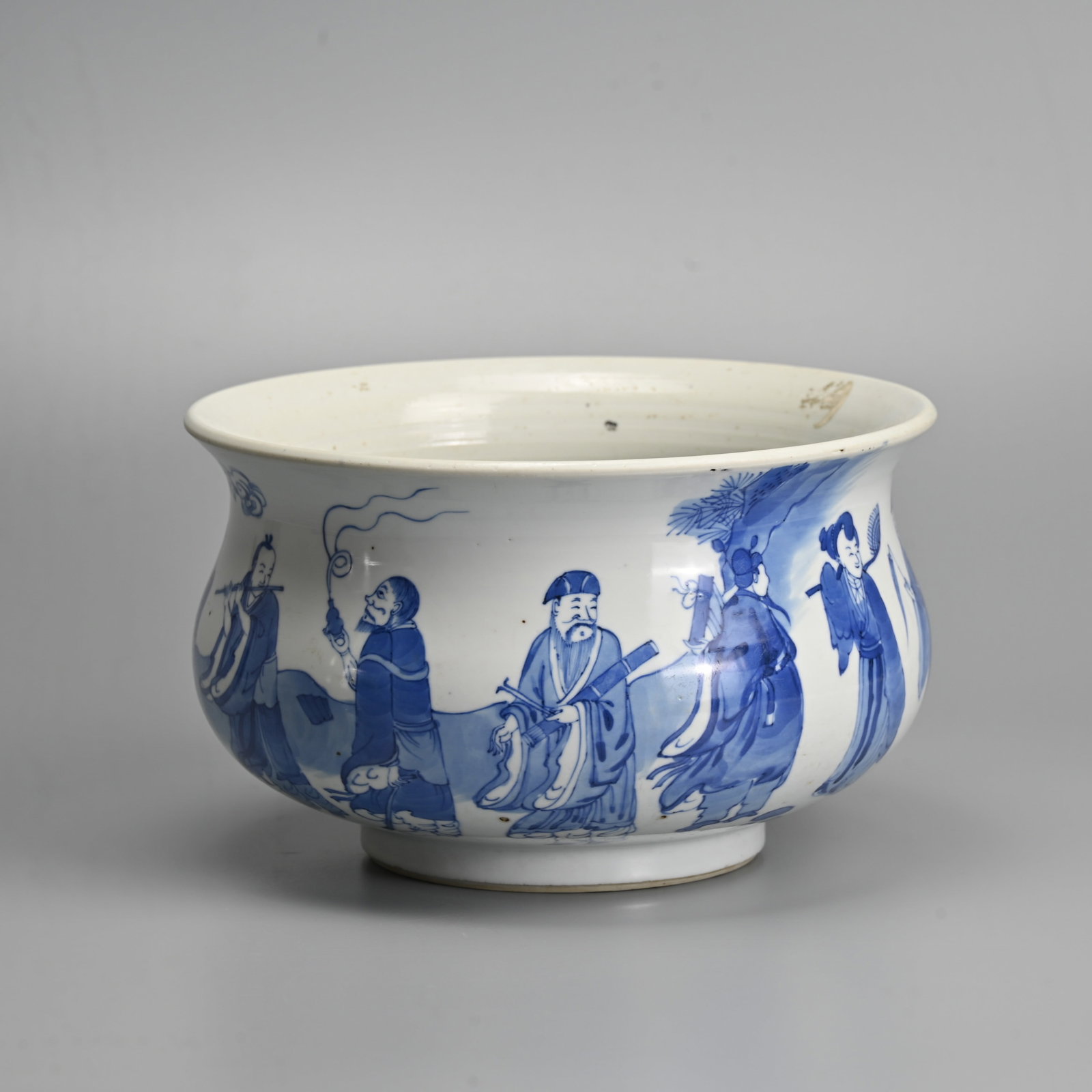 A CHINESE BLUE AND WHITE PORCELAIN BOMBE FORM CENSER, KANGXI STYLE.: Featuring the Eight Immortals standing before a seated figure of Shoulao beside rockwork and clouds. 22.5cm diam. 'Antique & Curiosity' label to base no. 1239.