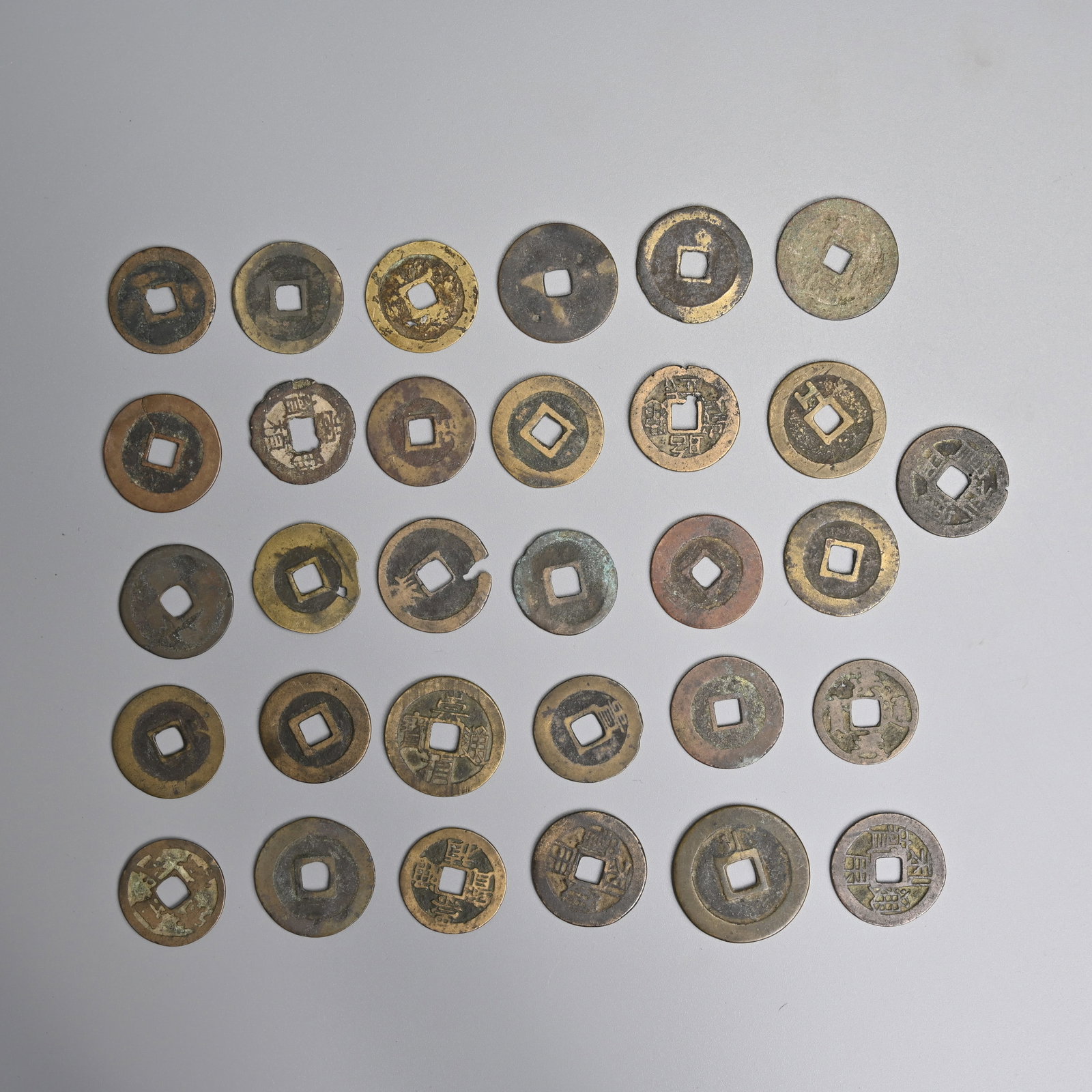 A QUANTITY OF CHINESE COINS, MAINLY MING DYNASTY (1368 - 1644 AD).: Thirty one coins in total. Total weight 93.9 grams.