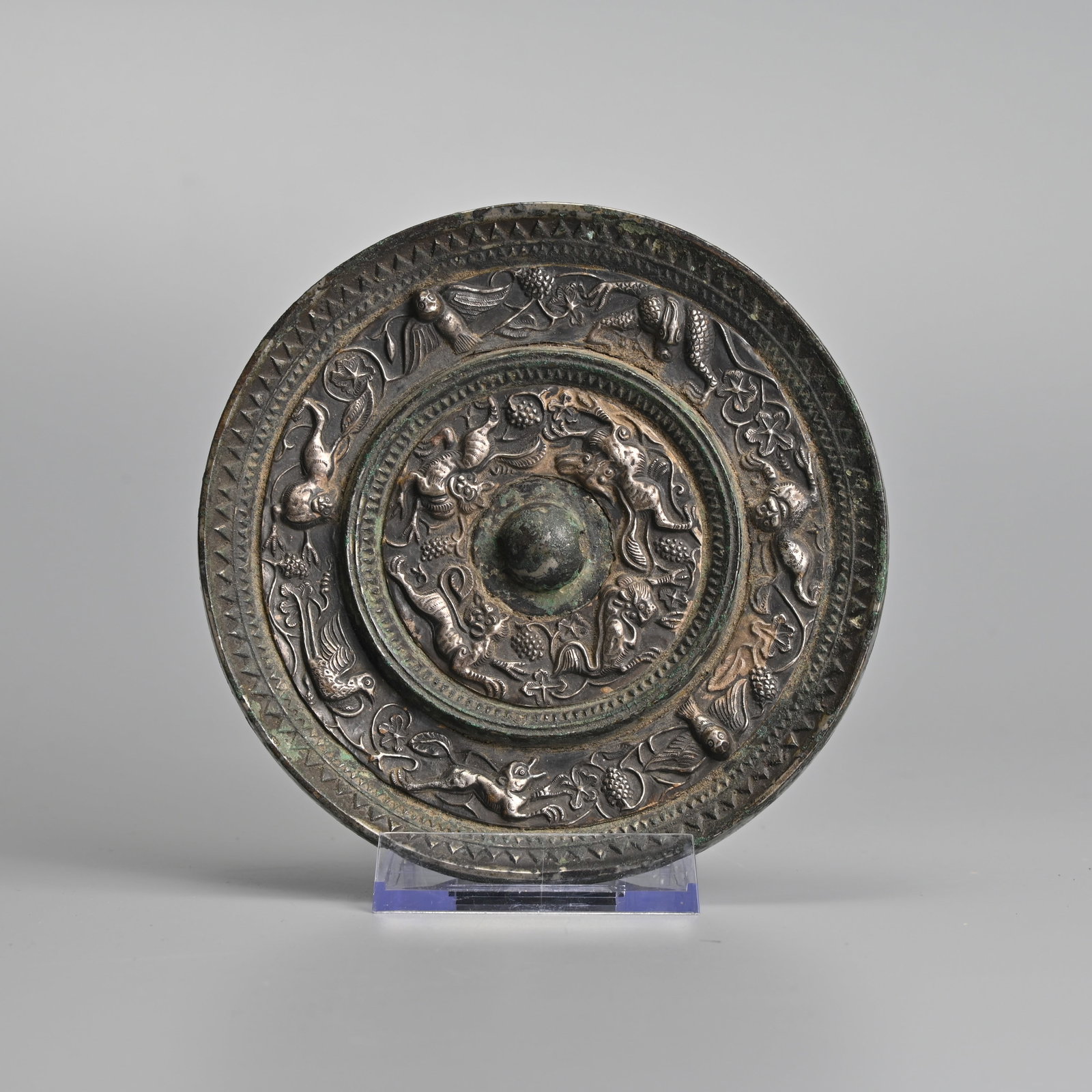 A RARE CHINESE SILVERED 'LION AND GRAPEVINE' BRONZE MIRROR, TANG DYNASTY (618-907). (1 of 5)
