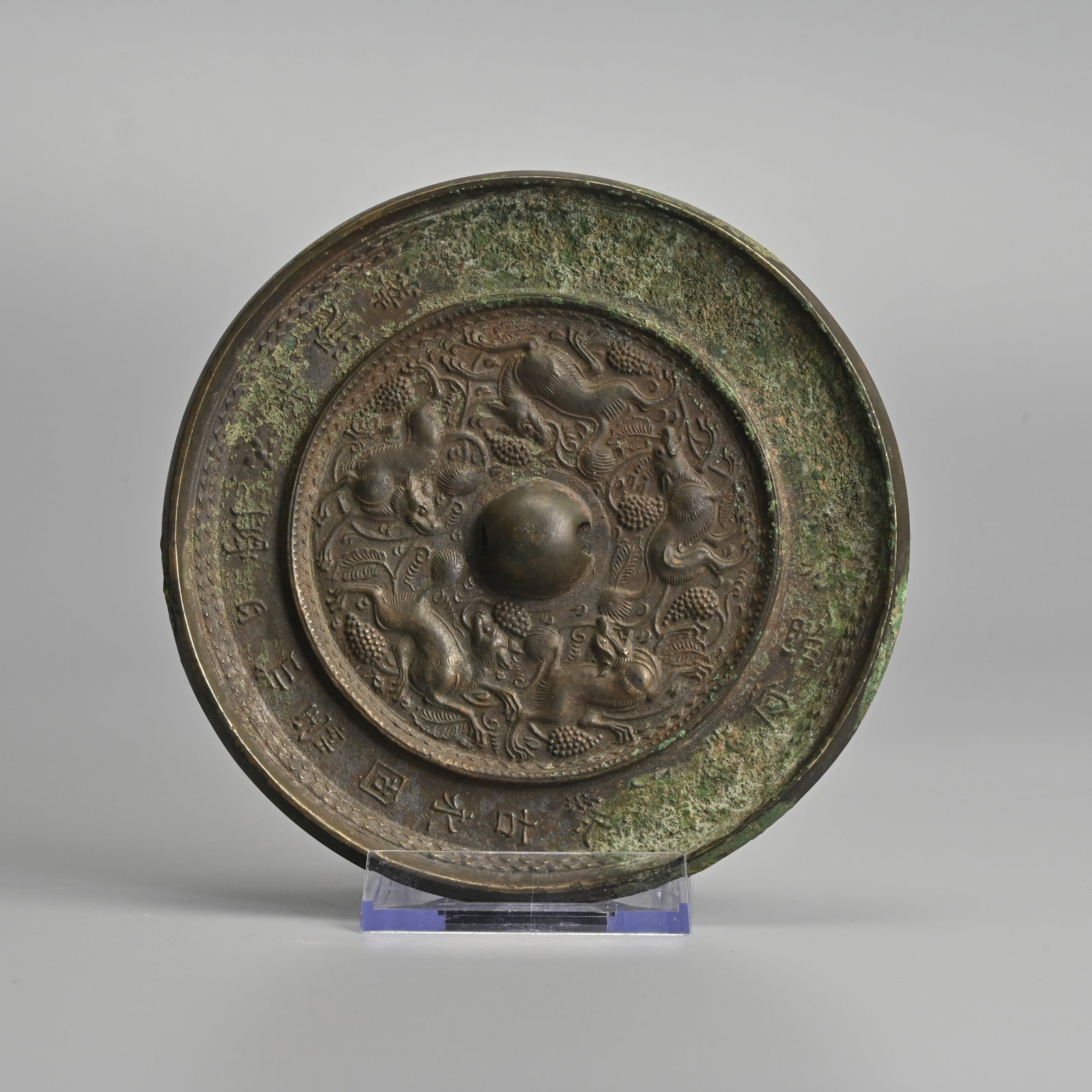 A CHINESE BRONZE 'BEASTS AND GRAPEVINE' MIRROR WITH POEM INSCRIPTION, POSSIBLY TANG DYNASTY. (1 of 4)
