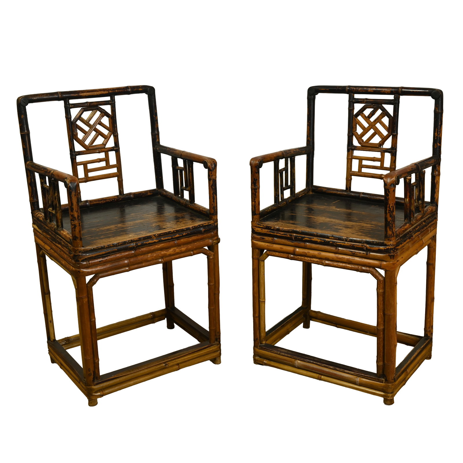 A PAIR OF CHINESE EXPORT BAMBOO LACQUERED CHAIRS, 20TH CENTURY.: Featuring open geometric fretwork and interlocking lattice designs to the arms and back rest. 49cm wide x 91cm tall x 39cm deep. (2).