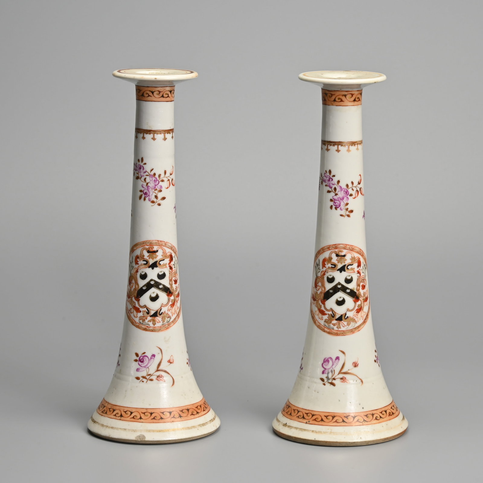 A PAIR OF CHINESE ARMORIAL FAMILLE ROSE PORCELAIN CANDLESTICKS, 18TH CENTURY. (1 of 7)