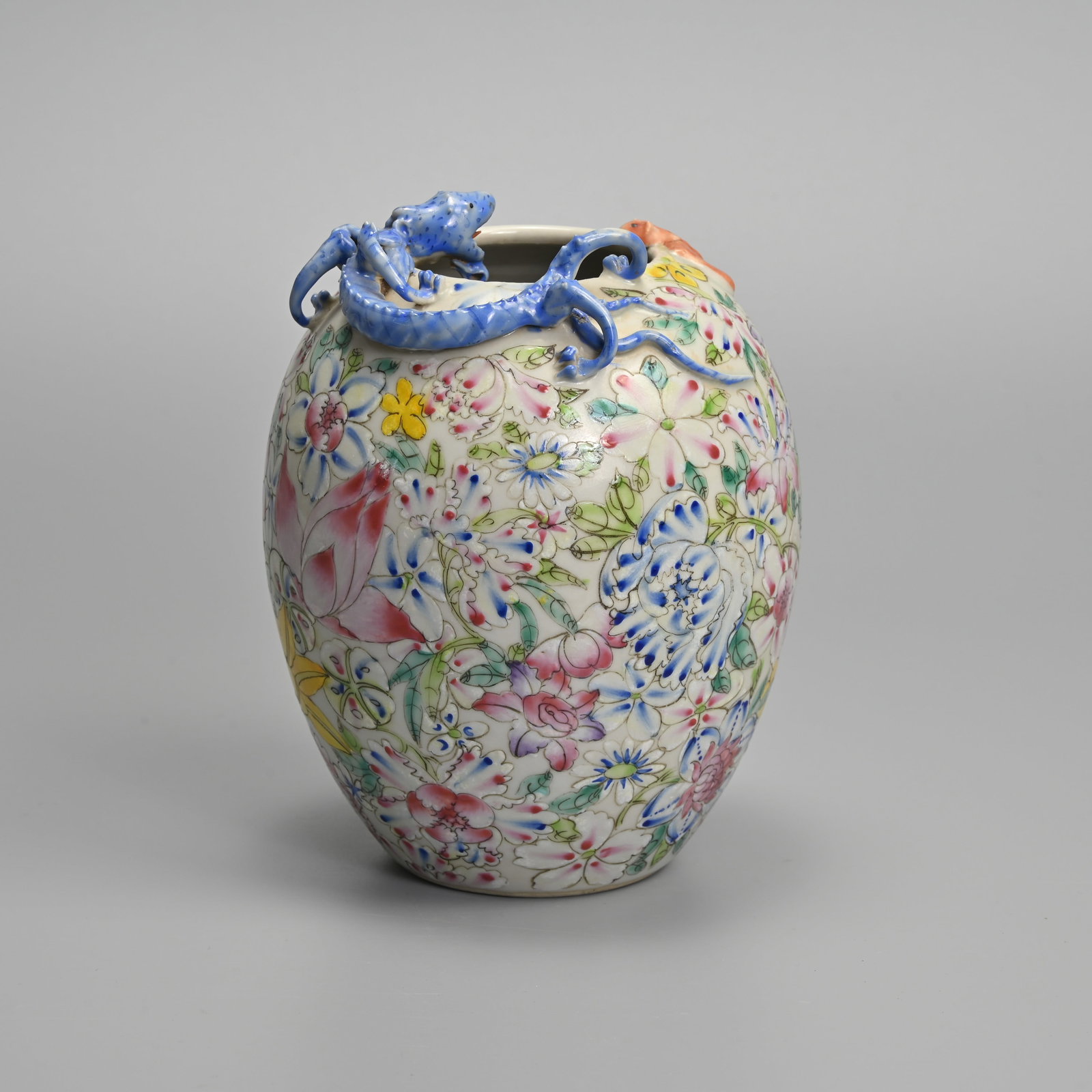 A CHINESE FAMILLE ROSE PORCELAIN MILLEFLEUR, CHILONG AND BAT PORCELAIN VASE, 19/20TH CENTURY.: A CHINESE FAMILLE ROSE PORCELAIN MILLEFLEUR, CHILONG AND BAT PORCELAIN VASE, 19/20TH CENTURY. The vase of ovoid form decorated with various flowers, with a moulded chilong and bat at the rim. Four cha