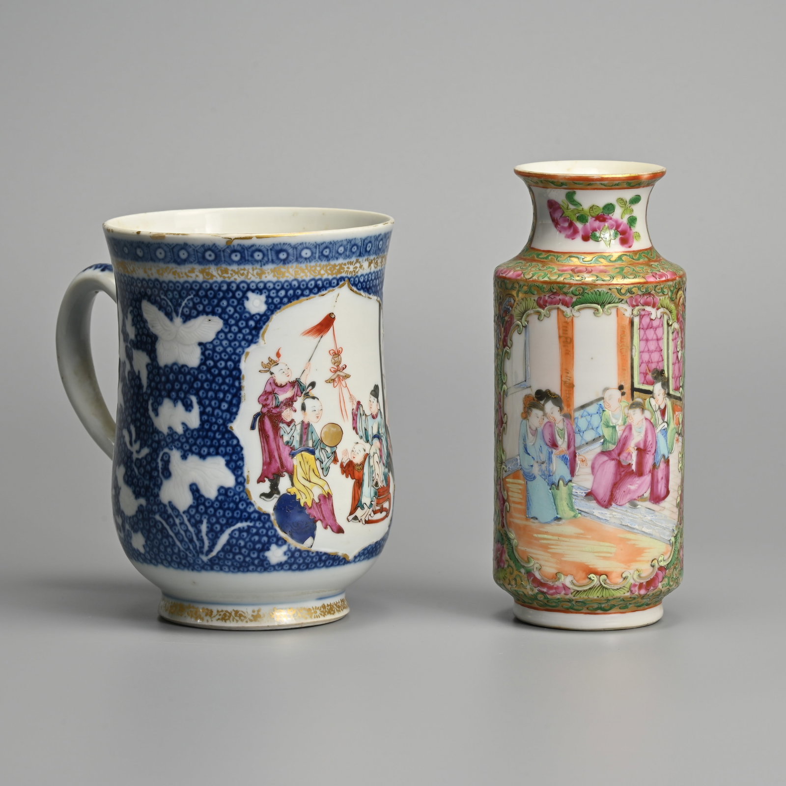 A CHINESE 18TH CENTURY FAMILLE ROSE BLUE AND WHITE PORCELAIN TANKARD, TOGETHER WITH A 19TH CENTURY: A CHINESE 18TH CENTURY FAMILLE ROSE BLUE AND WHITE PORCELAIN TANKARD, TOGETHER WITH A 19TH CENTURY CANTON FAMILLE ROSE VASE. The tankard decorated with Mandarin figures and children at play within a g
