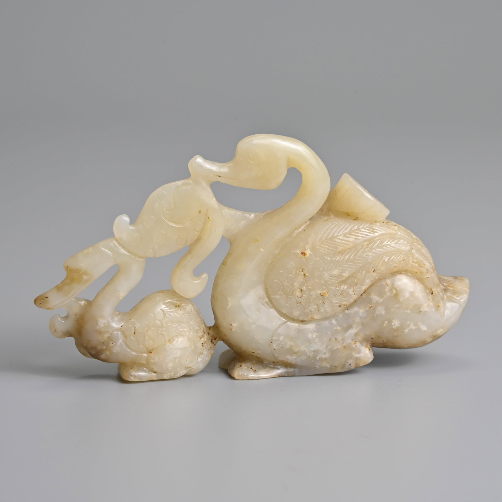 A CHINESE CARVED PALE CELADON JADE CRANES AND LOTUS GROUP. (1 of 5)