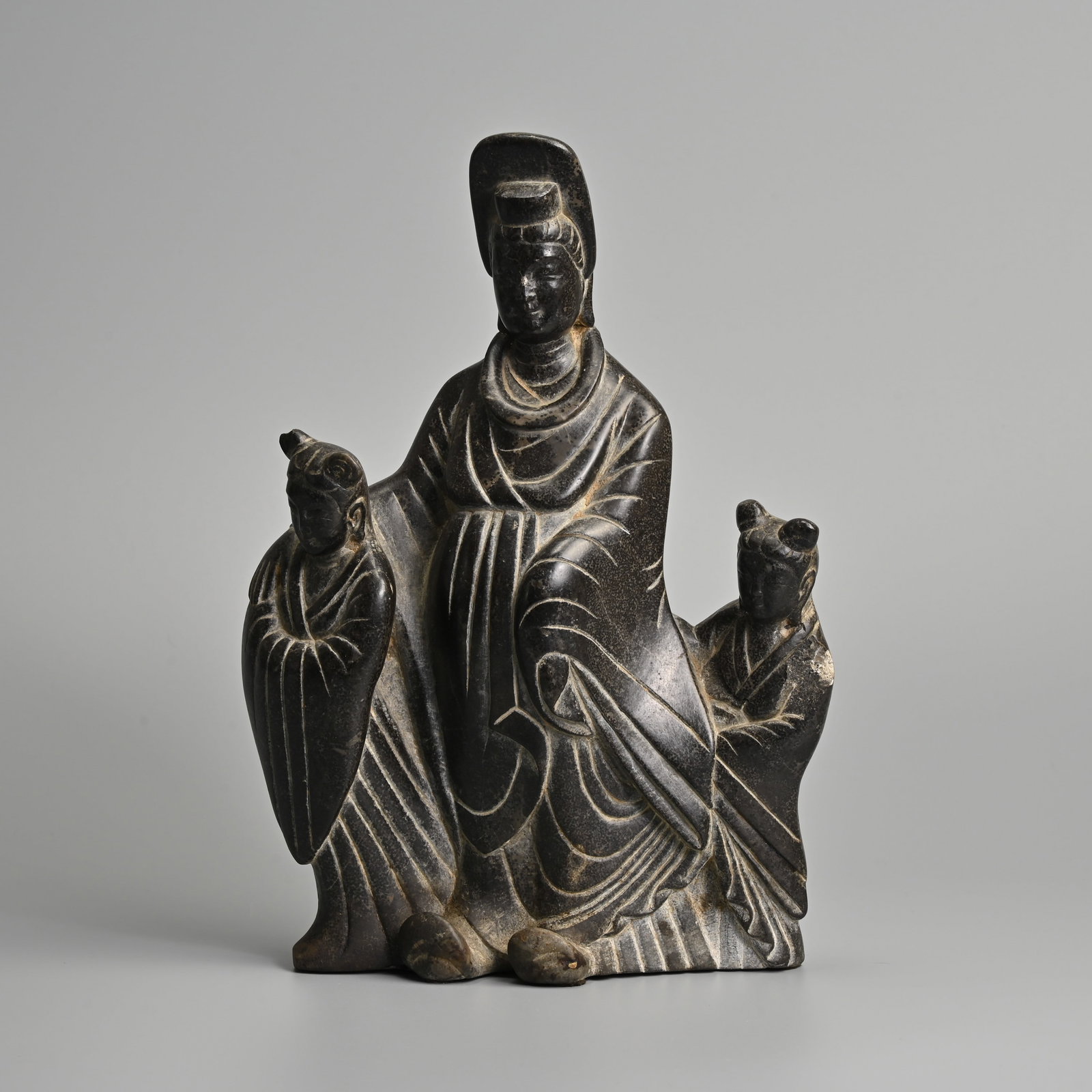 A CHINESE CARVED GREY STONE FIGURE OF GUANYIN WITH CHILDREN. (1 of 9)