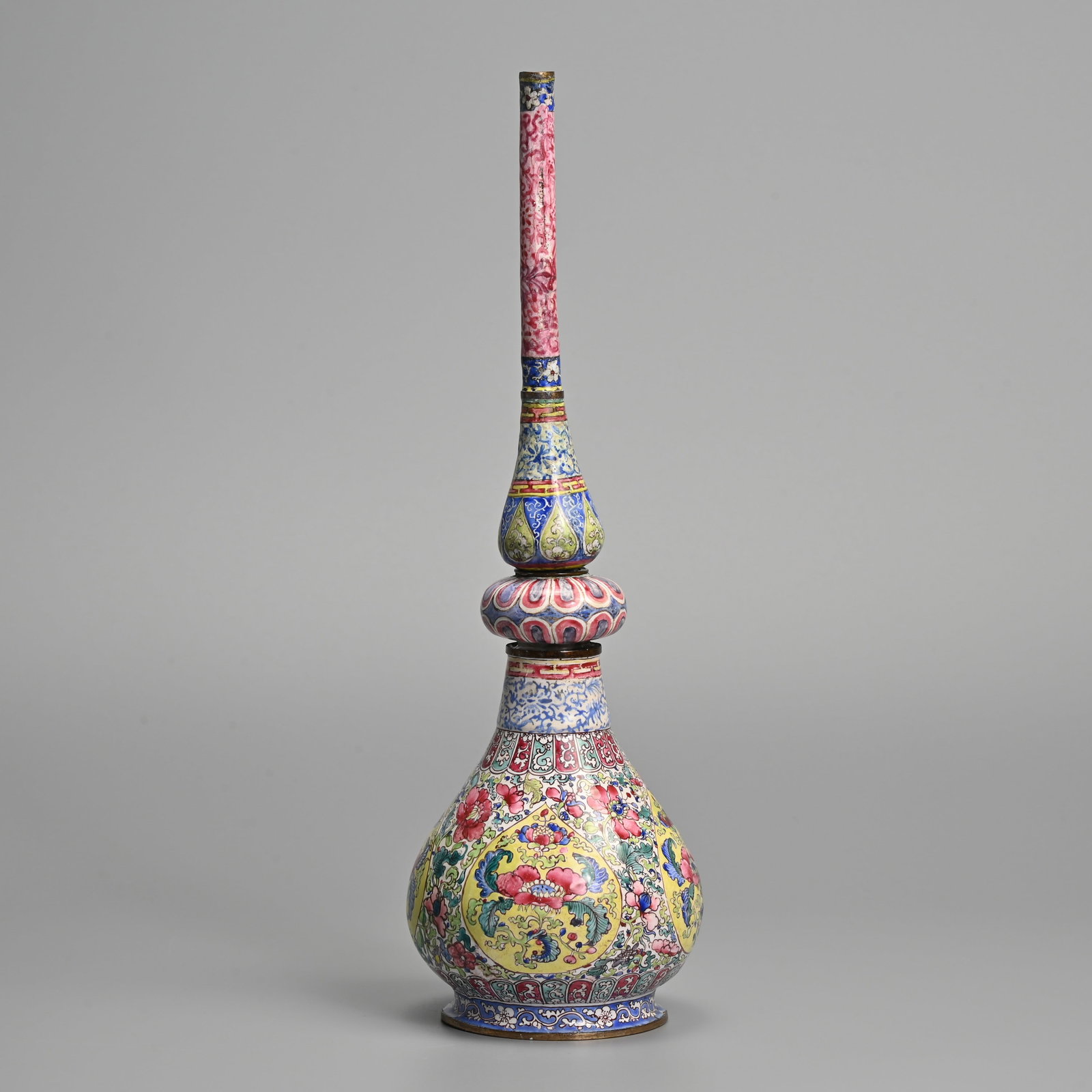 A CHINESE CANTON ENAMEL ROSE WATER SPRINKLER, 18/19TH CENTURY.: A CHINESE CANTON ENAMEL ROSE WATER SPRINKLER, 18/19TH CENTURY. In two sections with a central screw join, decorated with various flowers in colourful enamels. The base with blue enamelled flower motif