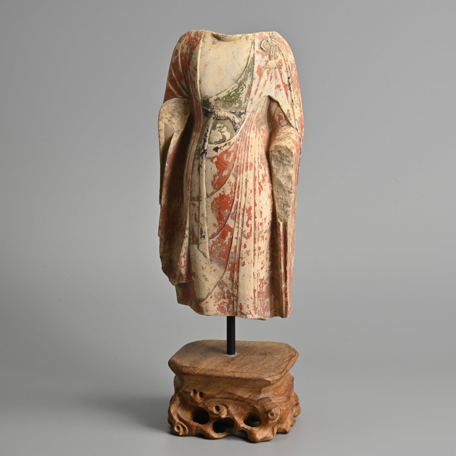 A CHINESE PAINTED WHITE MARBLE TORSO OF BUDDHA, MOUNTED ON STAND.: A CHINESE PAINTED WHITE MARBLE TORSO OF BUDDHA, MOUNTED ON STAND. Carved in the round dressed in robes tied at the shoulder and waist, slightly curved to the back, coloured in red, green and black pig