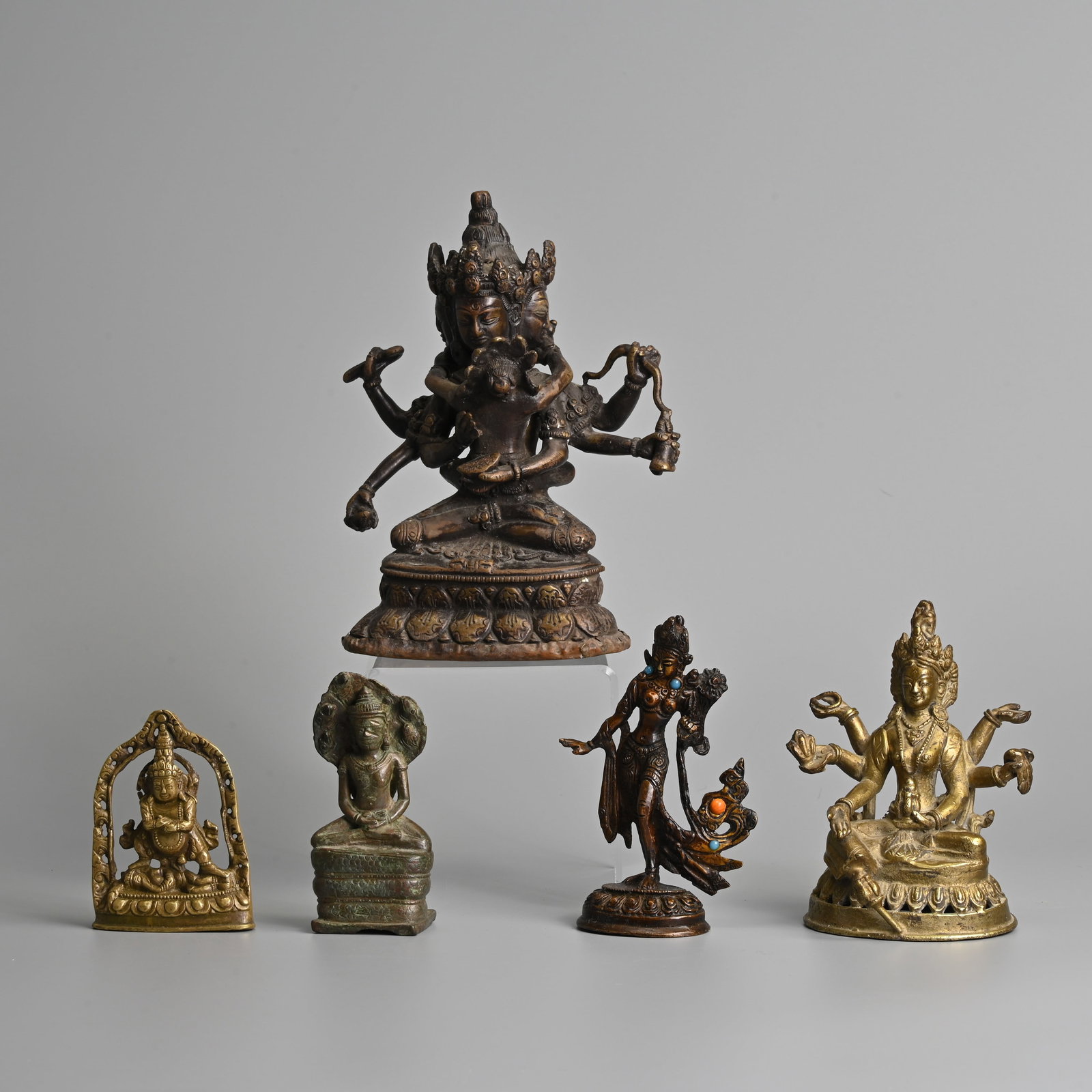 A GROUP OF TIBETAN, NEPALESE AND SOUTHEAST ASIAN BRONZE BRASS FIGURES OF BUDDHA, 19/20TH CENTURY. (1 of 13)