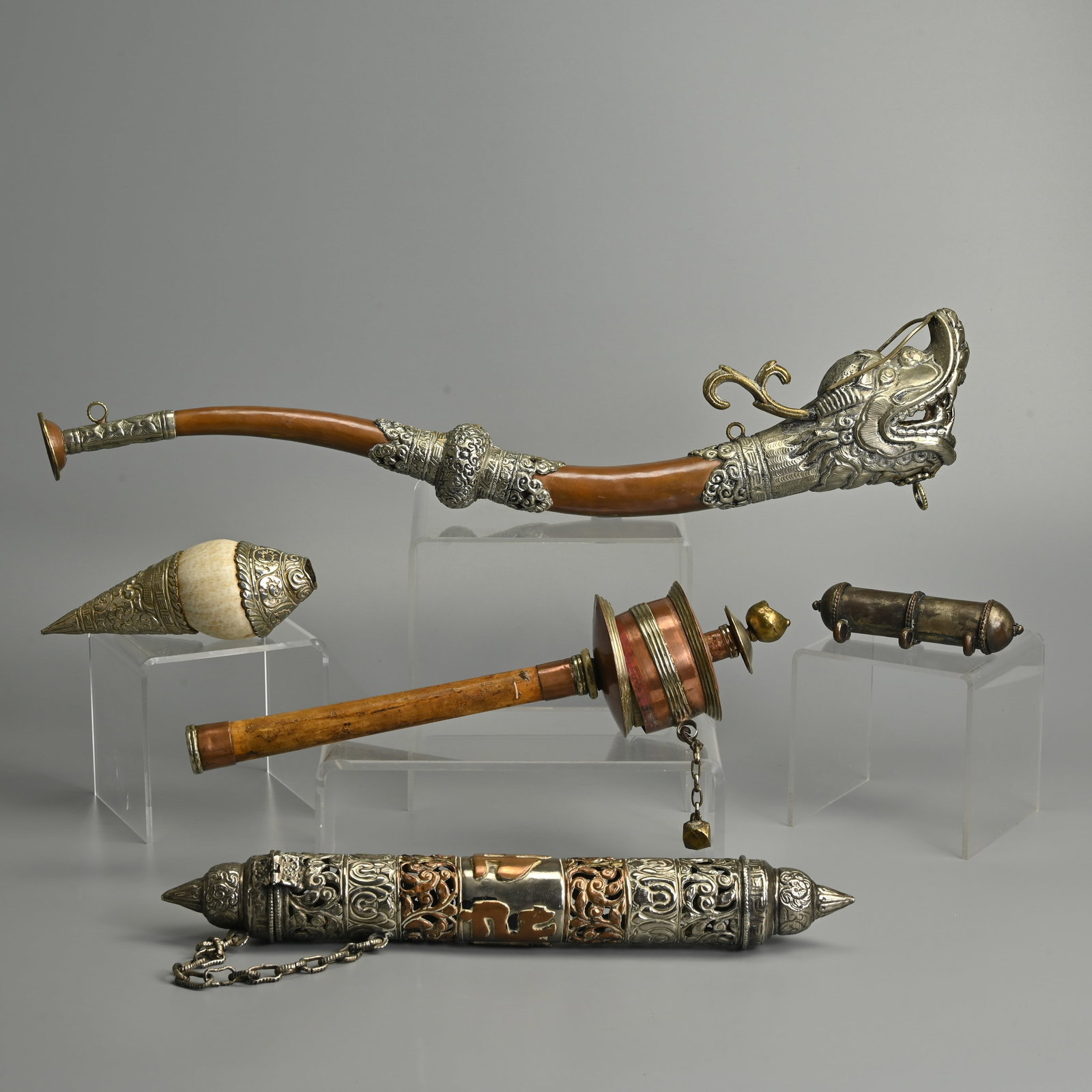 A GROUP OF TIBETAN METALWARE BUDDHIST ITEMS, PRAYER AMULETS, HORN AND PRAYER WHEEL, 20TH CENTURY. (1 of 14)