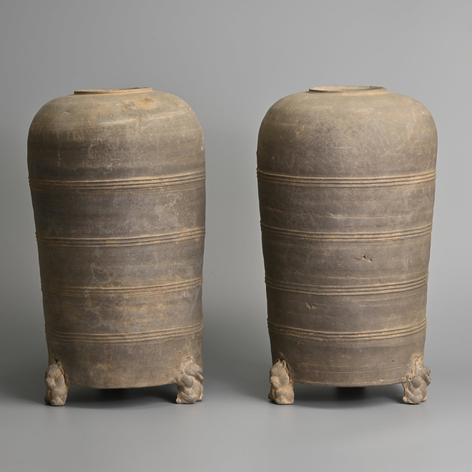 A PAIR OF LARGE CHINESE GREY POTTERY GRANARY JARS WITH BEAR SUPPORTS, HAN DYNASTY (206BC ? 220AD). (1 of 7)