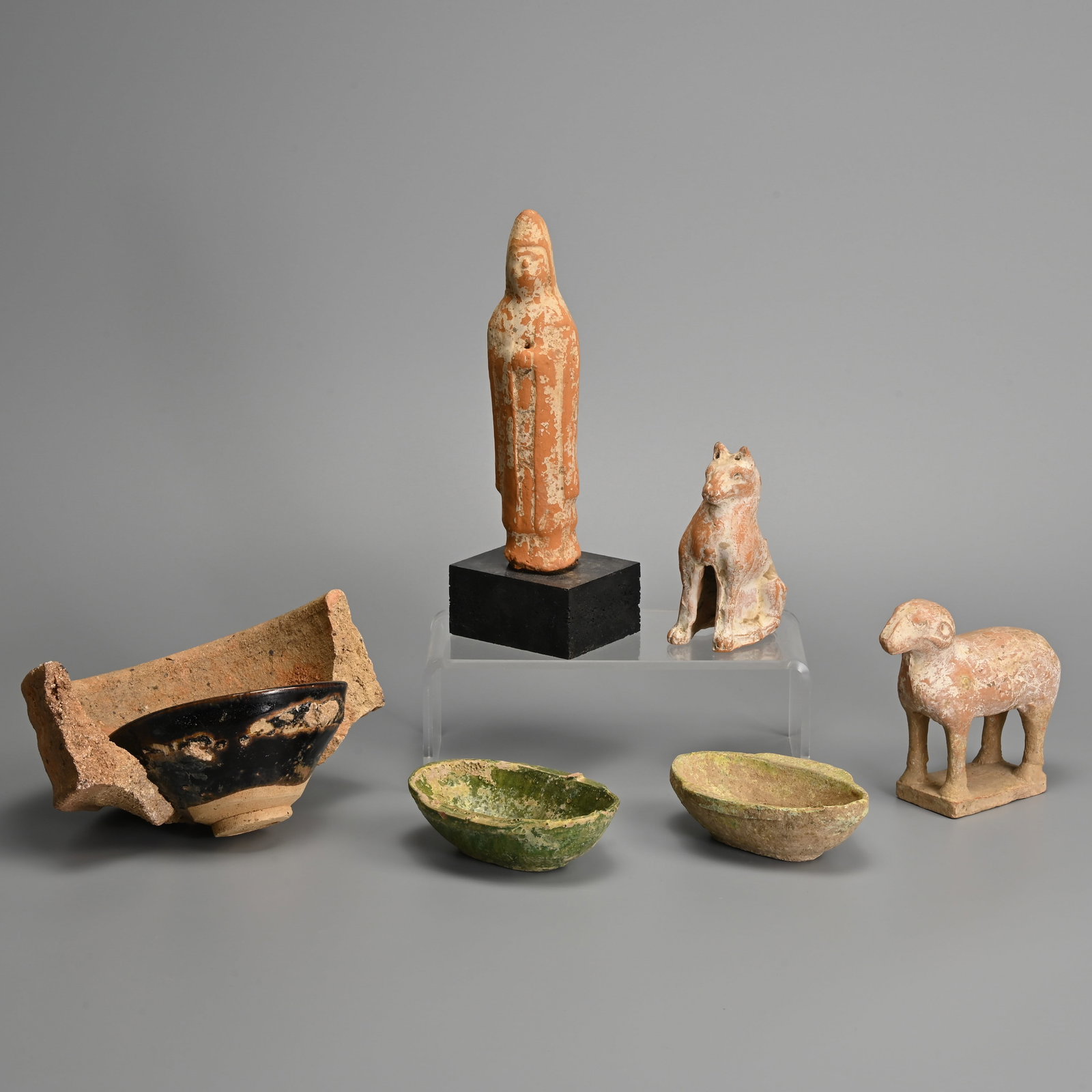A GROUP OF EARLY CHINESE CERAMICS, HAN / TANG / SONG DYNASTY.: A GROUP OF EARLY CHINESE CERAMICS, HAN / TANG / SONG DYNASTY. To include a pair of green lead glazed earthenware ear cups, Han dynasty; Red pottery figures of an attendant, a ram and dog, Tang dynasty
