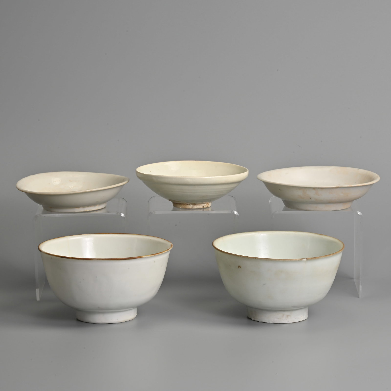 A GROUP OF CHINESE WHITE GLAZED BOWLS, VUNG TAO CARGO AND OTHERS, LATE SONG - 17TH CENTURY.: A GROUP OF CHINESE WHITE GLAZED BOWLS, VUNG TAO CARGO AND OTHERS, LATE SONG - 17TH CENTURY. To include two bowls with deep sides, Christie's Vung Tao Cargo lot stickers, Lot 468 and 469; Together with