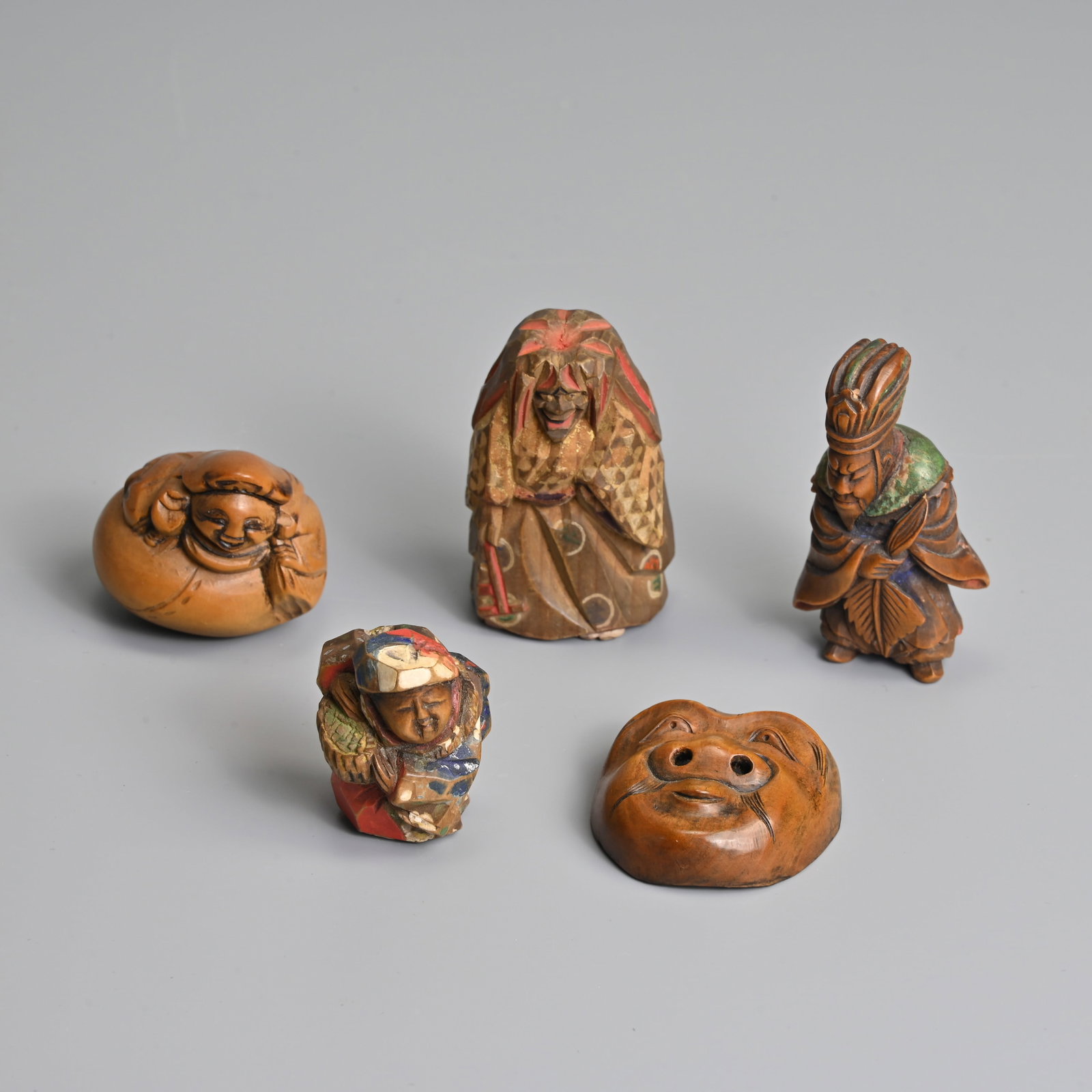 A GROUP OF JAPANESE CARVED WOOD AND BOXWOOD NETSUKE. (1 of 7)