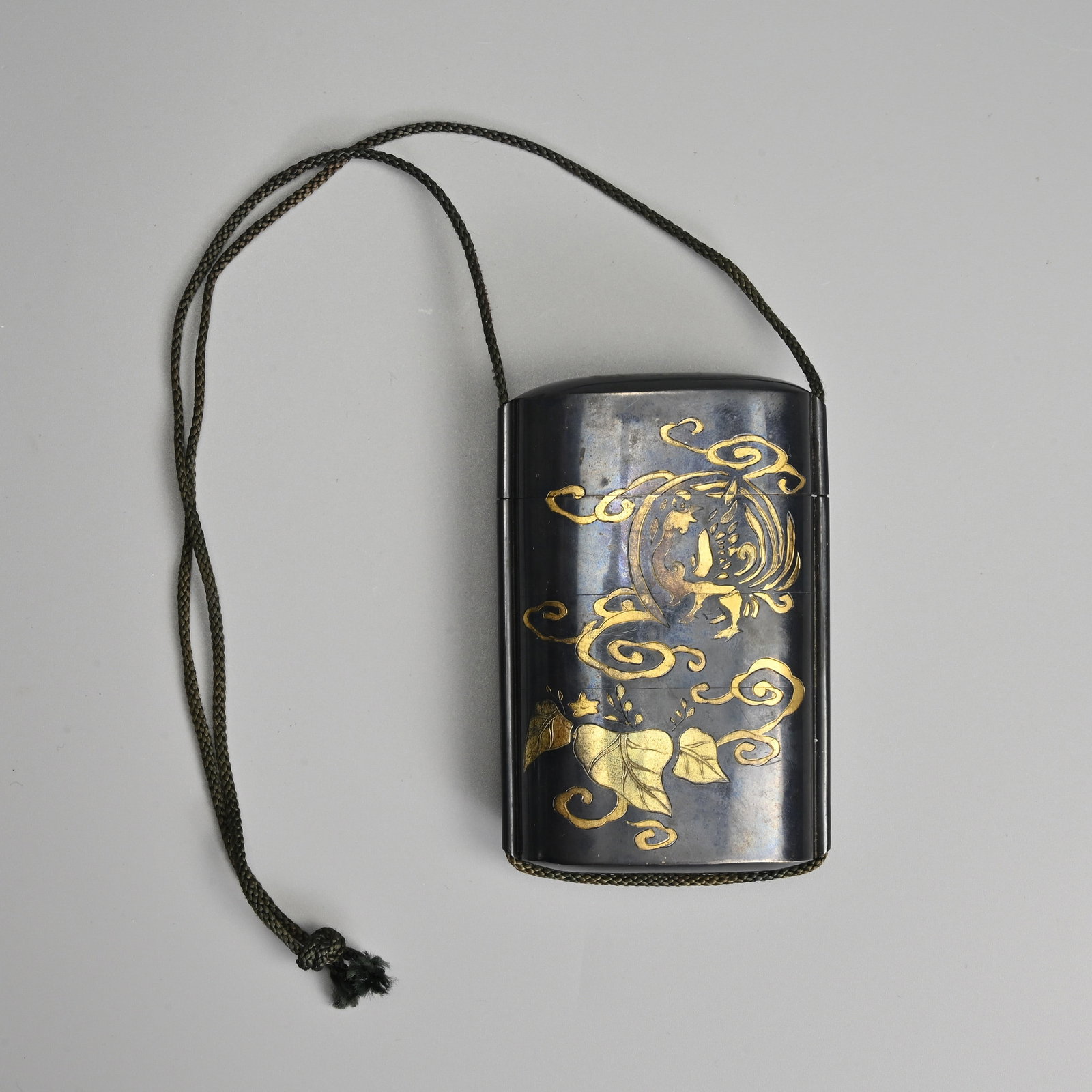 A RARE JAPANESE SINGLE CASED 'KINZOKU' METAL INRO, 19/20TH CENTURY.: A RARE JAPANESE SINGLE CASED 'KINZOKU' METAL INRO, 19/20TH CENTURY. Mixed metal case with cover incised to look like three layers below the cover, brass inlay featuring phoenix roundel with clouds and