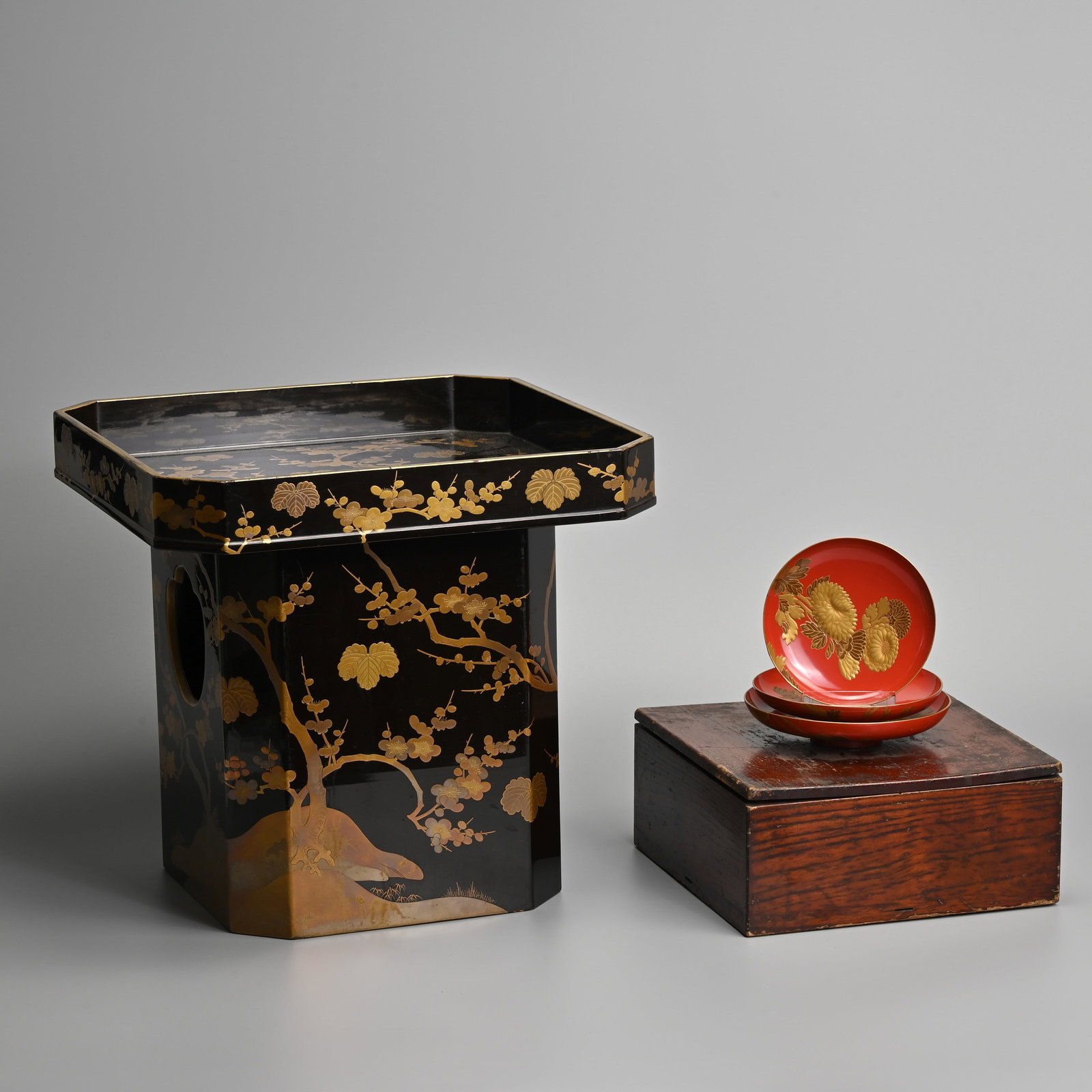 A JAPANESE LACQUER KAGETSUDAI TABLE TOGETHER WITH THREE GRADUATED SAKAZUKI, SAKE CUPS. (1 of 13)