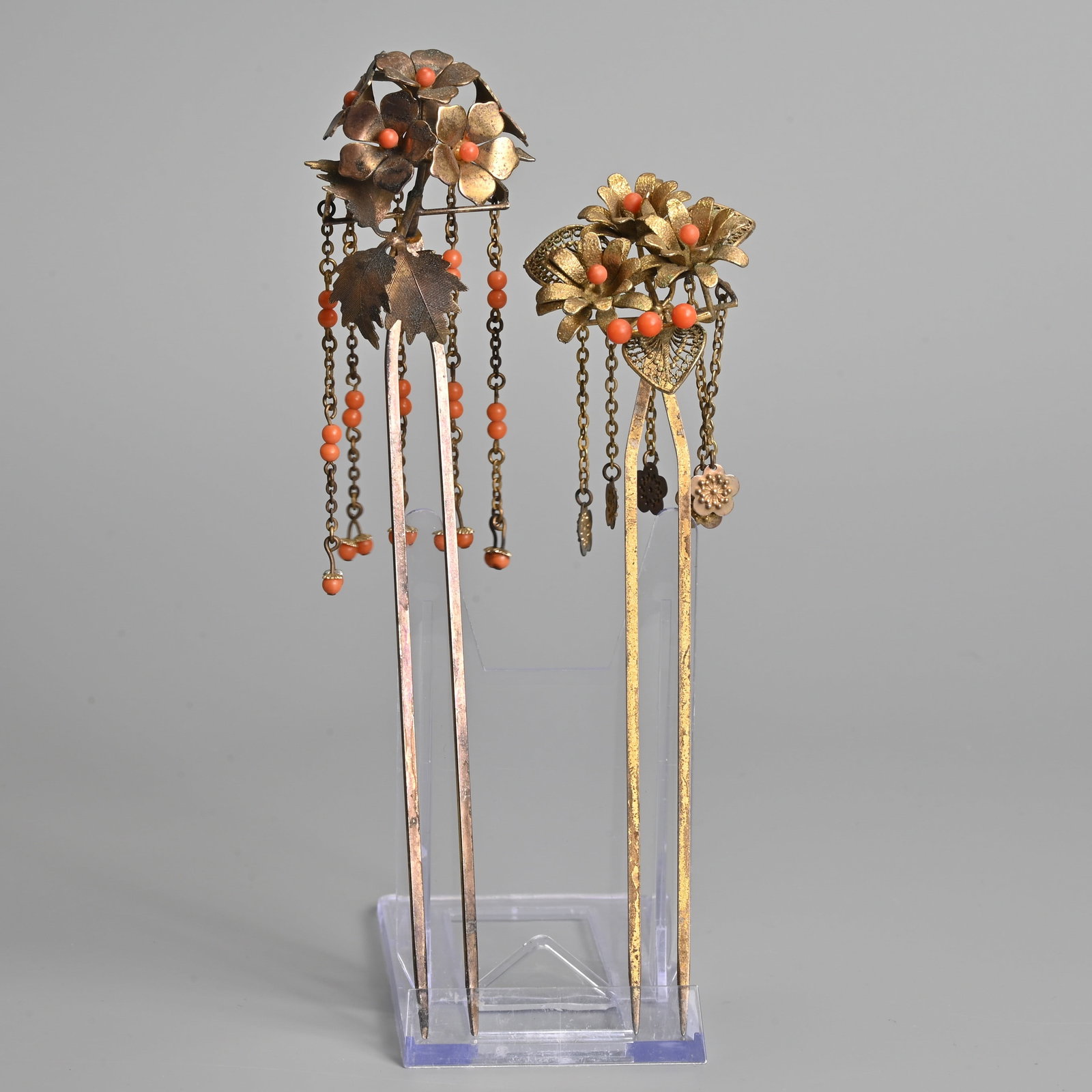 TWO JAPANESE BIRA BIRA KANZASHI, DANGLING HAIR PIN ORNAMENTS, 20TH CENTURY.: TWO JAPANESE BIRA BIRA KANZASHI, DANGLING HAIR PIN ORNAMENTS, 20TH CENTURY. Metal two pronged hair pins with floral decoration featuring dangling chains with flower heads and coral coloured beads. 17c