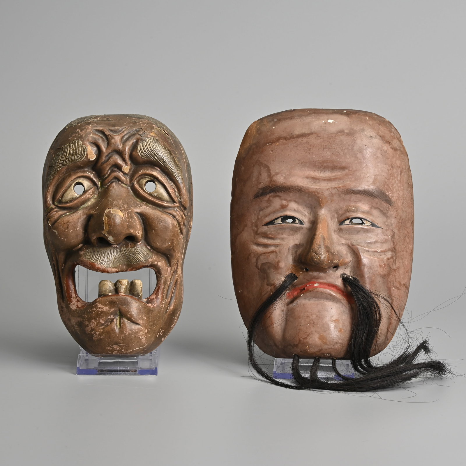 TWO JAPANESE CARVED WOOD LACQUER NOH MASKS, EDO / MEIJI PERIOD.: TWO JAPANESE CARVED WOOD LACQUER NOH MASKS, EDO / MEIJI PERIOD. The first of a bearded man; The other an elderly man with three teeth. 18.5cm and 19cm length. (2).