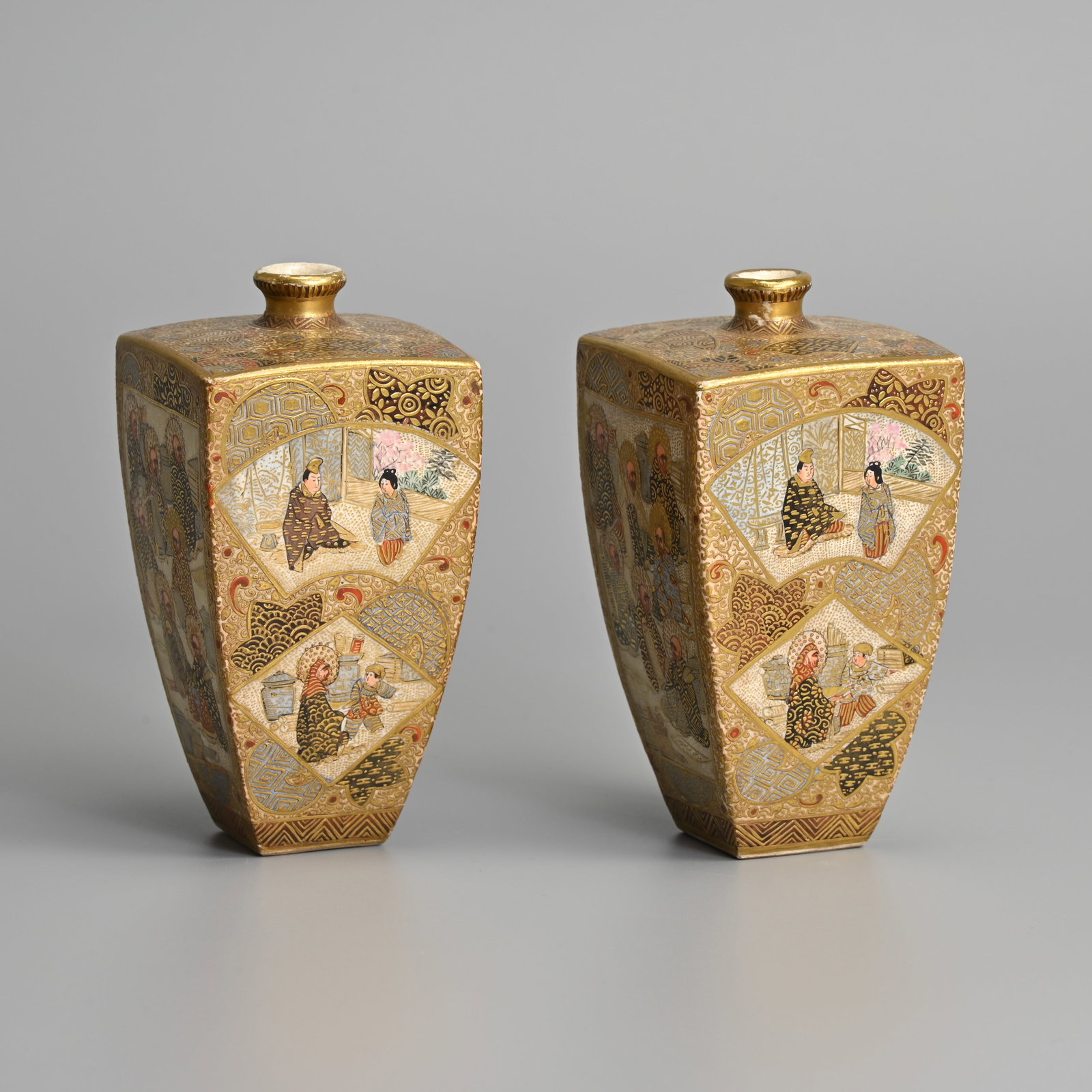 A PAIR OF JAPANESE SATSUMA WARE VASES, HODODA, LATE MEIJI PERIOD.: A PAIR OF JAPANESE SATSUMA WARE VASES, HODODA, LATE MEIJI PERIOD. Of square form decorated with panels of figural scenes. Marked to base. 12cm tall. (2).