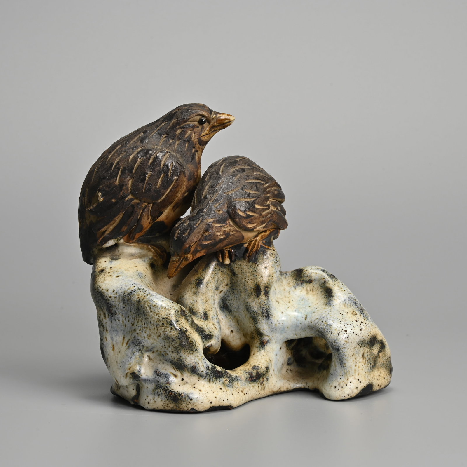 A JAPANESE GLAZED CERAMIC FIGURE OF QUAILS ON ROCKWORK, 20TH CENTURY. (1 of 6)