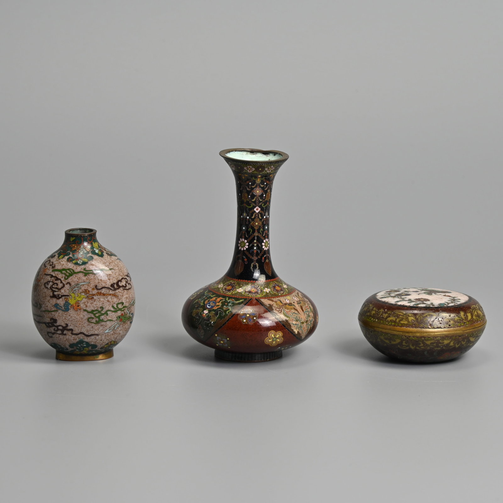 THREE JAPANESE CLOISONNE ITEMS, BOX ATTRIBUTED TO NAMIKAWA YASUYUKI (1845-1927), AND OTHERS, MEIJI: THREE JAPANESE CLOISONNE ITEMS, BOX ATTRIBUTED TO NAMIKAWA YASUYUKI (1845-1927), AND OTHERS, MEIJI PERIOD. To include a circular box and cover decorated with butterfly and flowers with turquoise inter