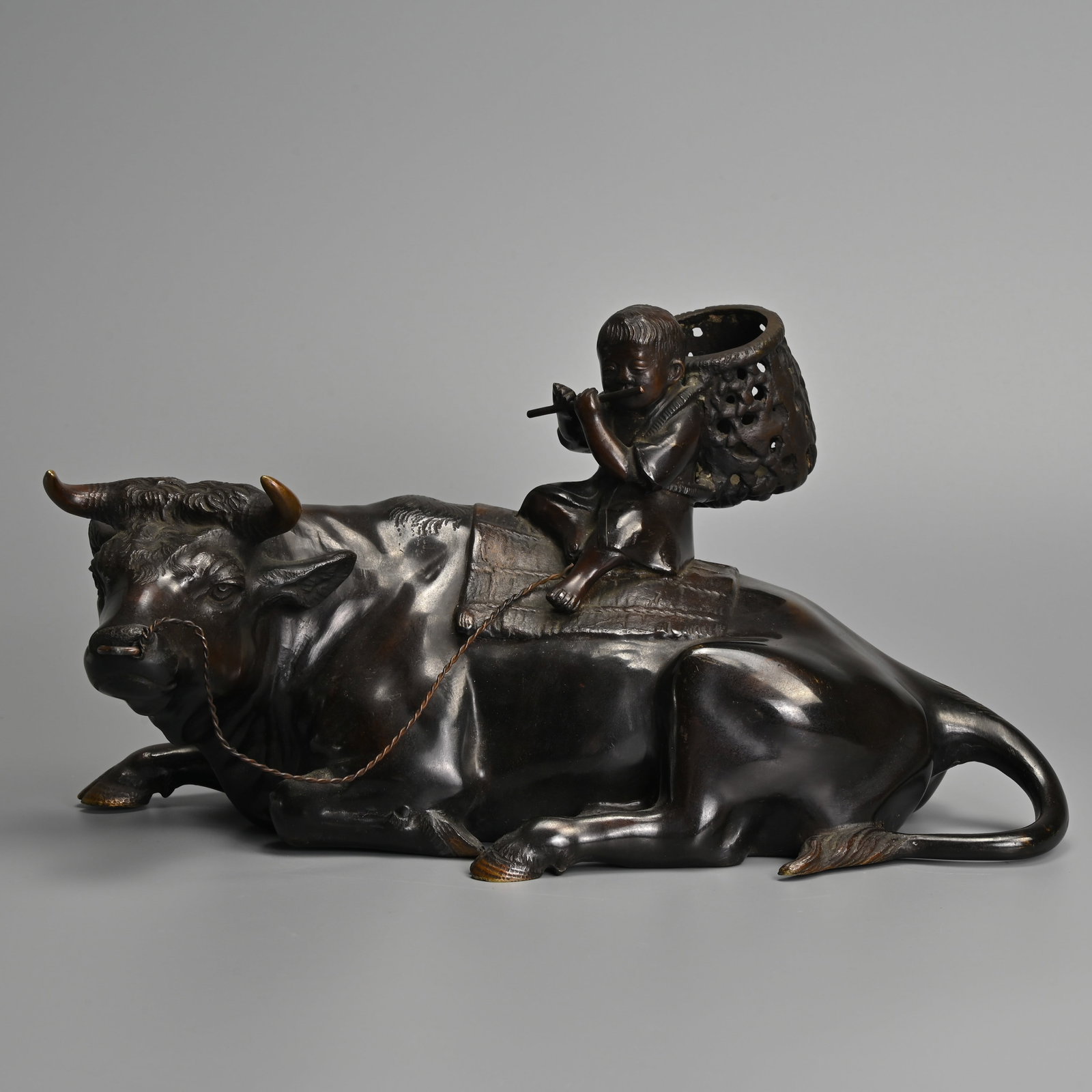 A LARGE JAPANESE COMMEMORATIVE BRONZE MODEL OF A BOY ON AN OX, SIGNED WITH COMMEMORATIVE: A LARGE JAPANESE COMMEMORATIVE BRONZE MODEL OF A BOY ON AN OX, SIGNED WITH COMMEMORATIVE INSCRIPTION, CIRCA 1960. The presentation inscription dating to Showa 35 for 1960, commemorating a 10 year anni