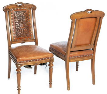 Pair of Embossed Leather Upholstered Chairs: 38.75" high x 18" wide x 22" deep Condition: Torn on the bottom