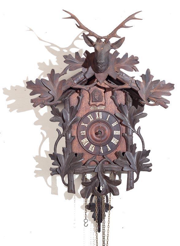 Figural Cuckoo Wall Clock with Brass Movement: Condition: crack across face 23" tall x 18" wide Provenance: The Estate of Andy and Bea Copeland Note: This antique clock is sold "where-is, as-is" and Vogt Auction makes no guarantee as to the workin