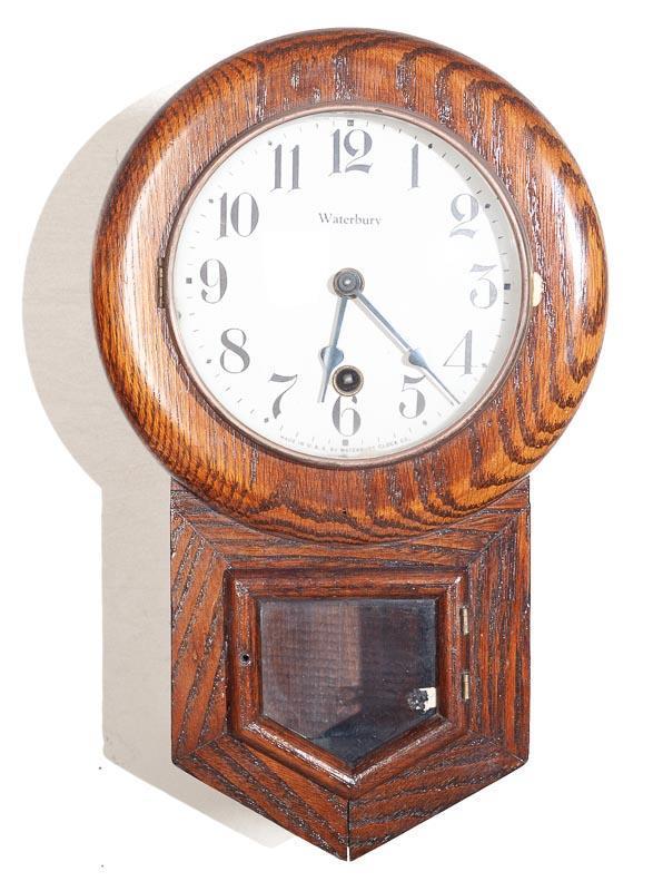 Miniature Waterbury Wall Clock, Time Only: 14" tall x 9" wide Provenance: The Estate of Andy and Bea Copeland Note: This antique clock is sold "where-is, as-is" and Vogt Auction makes no guarantee as to the working order or completeness of thi