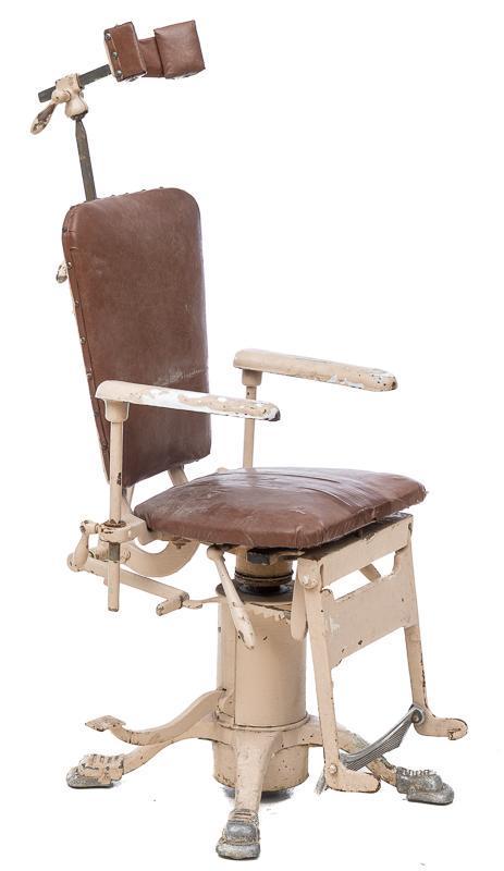 Early 20th c. Dentist Chair: Early 20th century, painted white cast iron frame, leather seat, leather headrest, cast iron foot rest, reclining seat, adjustable footrest. Provenance: A King William, TX Estate 51.5" tall x 21" wide