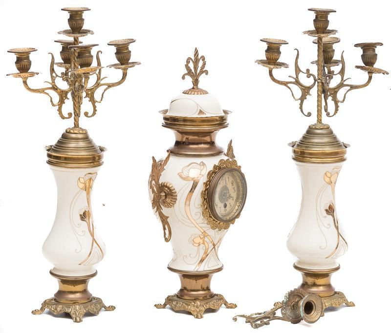 Clock Garniture Set: 3-piece set: 1-clock, 2-candelabras, bronze and porcelain, figural, white and gold motif 22" tall x 10" wide/ Largest Condition: Damage to candle arm State-wide delivery is available for this item. Pl
