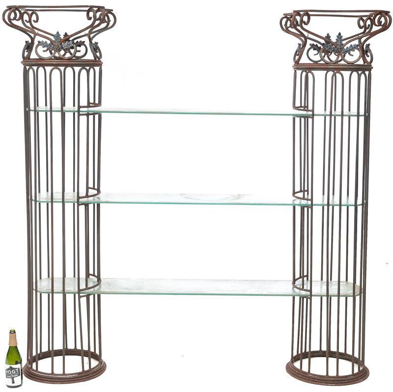 Metal Garden Shelves: Metal rebar, scrolled accents, leaf accents, 3 large glass shelves. Condition: Oxidization 76" tall x 16" diameter/ Columns 71" long x 12" wide/ Glass shelves State-wide delivery is available for this