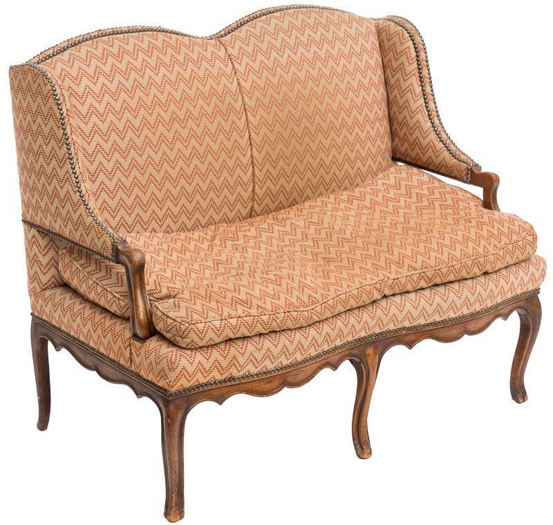 Feather Stuffed Loveseat: Feather seat cushion, peach upholstery, double arched top, open arms, 6-saber legs, stud accents Provenance: A Houston, TX Estate 38" tall x 45" wide x 29" deep State-wide delivery is available for th