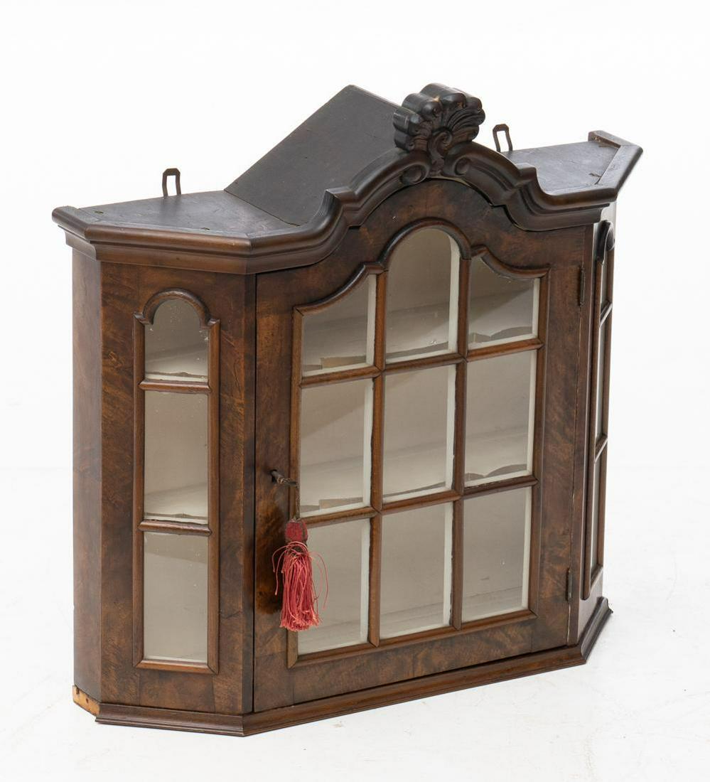 Small Glazed Wall Shelf: 2-doors, carved mantle, arched doors, cream interior, includes key. 25" tall x 25.5" wide x 7" deep State-wide delivery is available for this item. Please email shipping@vogtauction.com or call 210-82