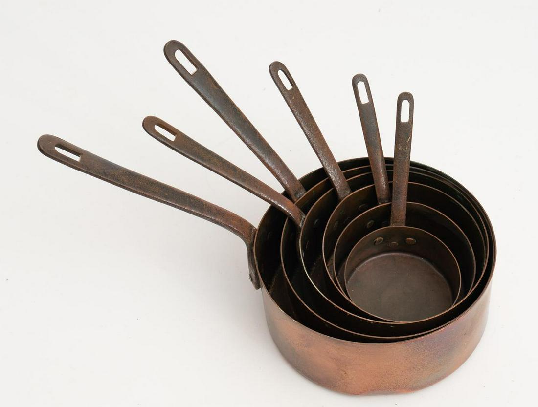 Lot of 6 Copper Pots: Graduated pot set, copper pots with iron handles. Condition: Light abrasions, oxidization 16" long/ Largest