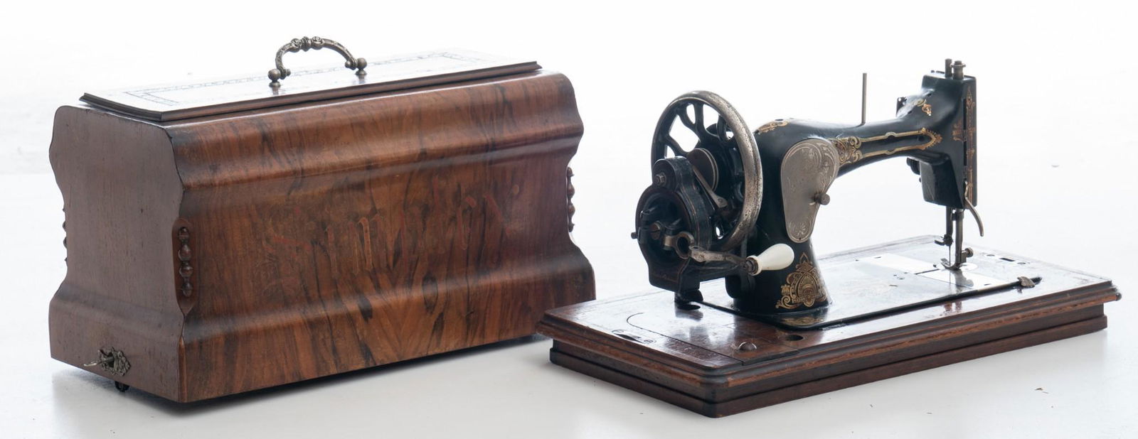 Vintage Sewing Machine: Unmarked, stamped 1907360, black, iron, hand-painted accents, includes wooden carrying box, machine rests on wooden base with measuring marks 10" tall x 20" wide x 10" deep