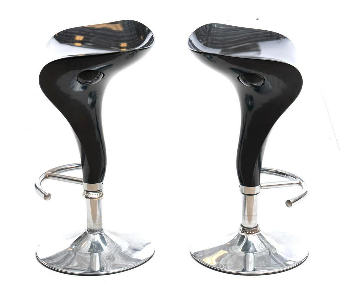 Pair of Barstools: Black acrylic seats with chrome stands, chrome footrests, adjustable base. 28" tall x 15.5" wide/ Each Condition: Scuffs to seats State-wide delivery is available for this item. Please email shipping@