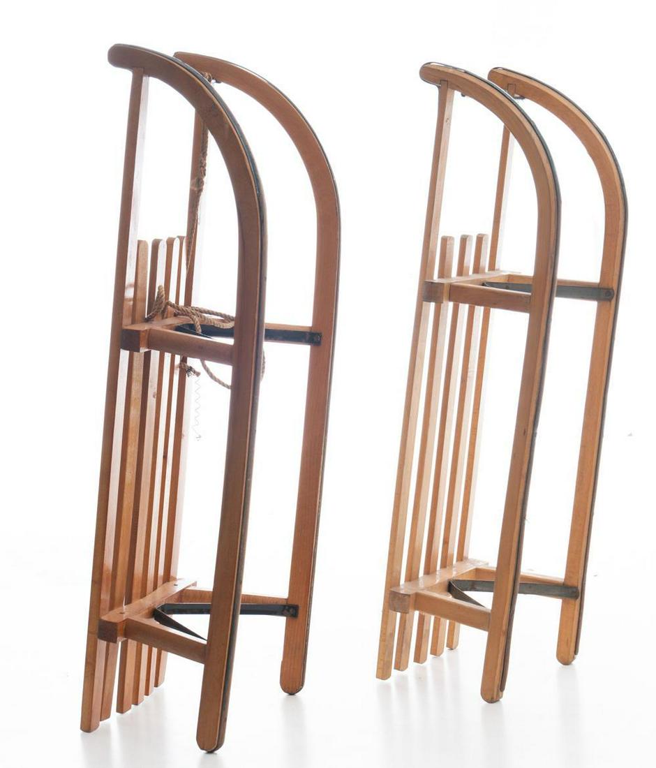 Pair of Rustic Sleds: Stamped "Davos 100" and "Intersport", metal rails 12" tall x 40.5" long x 14" wide/ Largest State-wide delivery is available for this item. Please email shipping@vogtauction.com or call 210-822-6155 f
