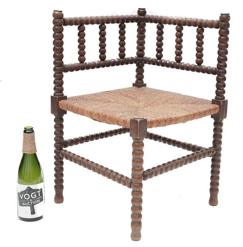 Corner Chair: Petite corner chair, circa 1860, cord seat, turned legs 26” tall x 22.5” wide State-wide delivery is available for this item. Please email shipping@vogtauction.com or call 210-822-6155 for a quote