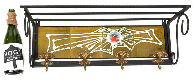 Mid-Century Tile Wall Rack: Mid-Century tile wall rack, floral motif, with wooden hooks 10" tall x 28.5" wide x 9" deep State-wide delivery is available for this item. Please email shipping@vogtauction.com or call 210-822-6155 f
