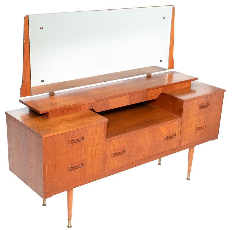 Mid-Century Teak Dressing Table: Mid-Century teak dressing table, mirrored, 5-drawers, wooden drawer pulls 46.5" tall x 57" wide x 16" deep State-wide delivery is available for this item. Please email shipping@vogtauction.com or call
