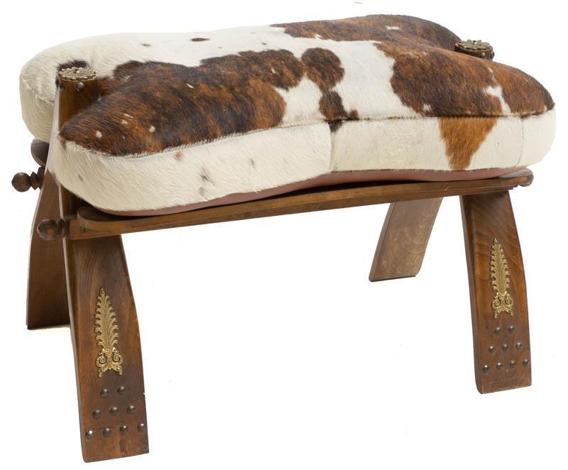 Cow Hide Footstool: Cow hide footstool, metal accents 15" tall x 14" wide State-wide delivery is available for this item. Please email shipping@vogtauction.com or call 210-822-6155 for a quote. IN-HOUSE SHIPPING is 