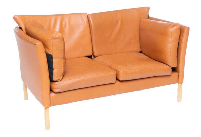 Mid-Century Danish Sofa: Mid-Century Danish sofa, faux leather, wooden legs 34" tall x 58.5" wide x 32" deep Condition: Scuff to back corner State-wide delivery is available for this item. Please email shipping@vogtauction.co