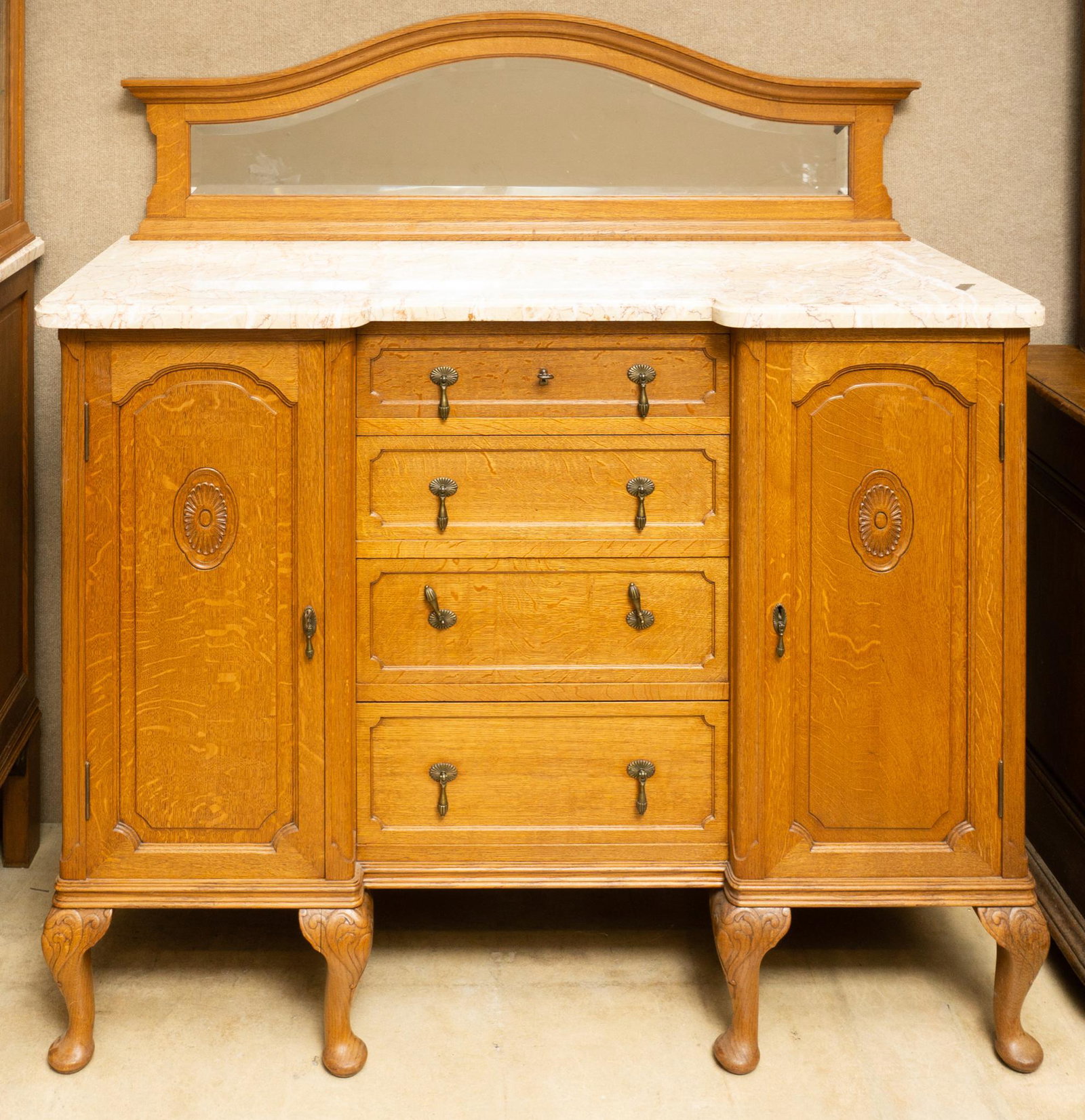 Mirrored Marble Top Sideboard: Mirrored sideboard, carved accents, metal accents, brown and tan marble 60" tall x 55" wide x 21" deep State-wide delivery is available for this item. Please email shipping@vogtauction.com or call 210