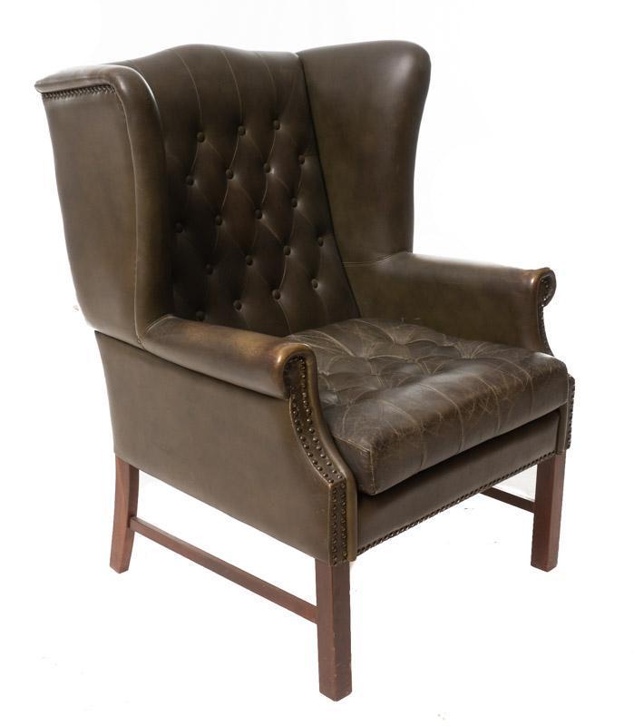 Mid-Century Leather Wingback Arm Chair: Provenance: An Olmos Park, TX Estate Mid-Century leather wingback arm chair, button back, wooden legs 39" tall x 25.5" wide x 26.5" deep State-wide delivery is available for this item. Please email sh