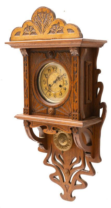 Vintage Wall Hanging Clock: Vintage wall hanging clock, carved, patinated clock face, includes pendulum 36" tall x 16" wide x 8" deep State-wide delivery is available for this item. Please email shipping@vogtauction.com or call 