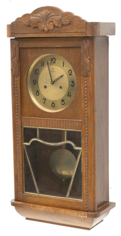 Vintage Genfa Wall Hanging Regulator Clock: Vintage Genfa wall hanging regulator clock, includes pendulum and key, wooden case 30.5" tall x 14" wide x 7" deep State-wide delivery is available for this item. Please email shipping@vogtauction.com