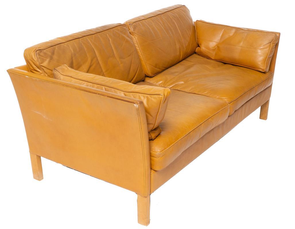 Danish Mid-Century Leather Sofa: Danish Mid-Century leather sofa, 2-seat, wooden legs 30" tall x 66" wide x 32" deep State-wide delivery is available for this item. Please email shipping@vogtauction.com or call 210-822-6155 for a quo